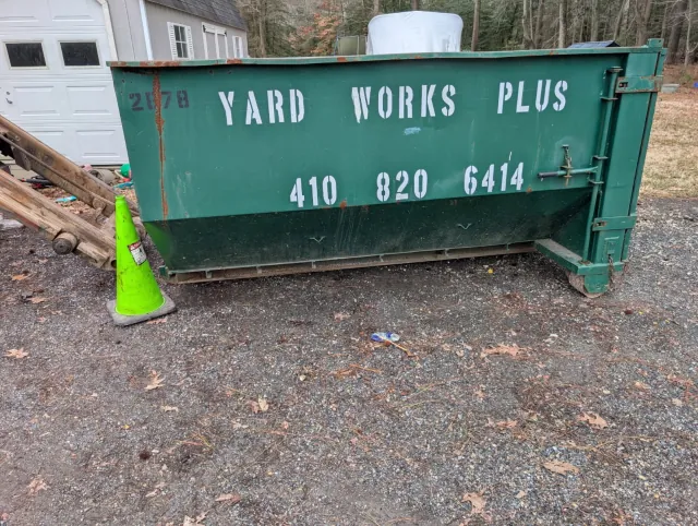 10 yard roll-off dumpster in a residential garage area